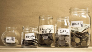 Image of savings jars - travel, health, education, car, house