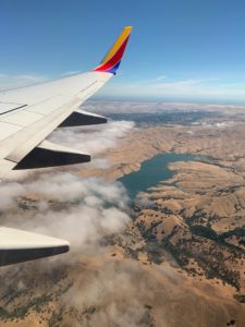 Photo of airplane wing above the earth