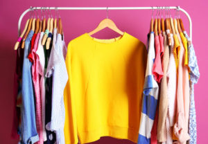 Image of clothes hanging on a closet rod