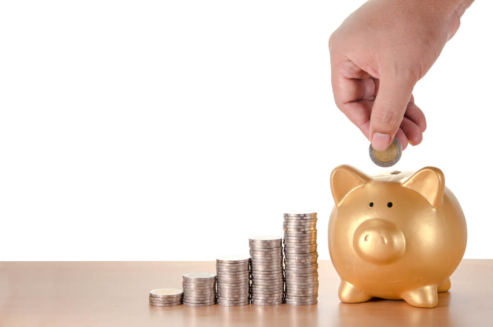 Image of coins stacked with gold piggy bank