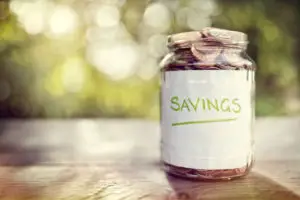 Image of Jar full of change and paper saying savings