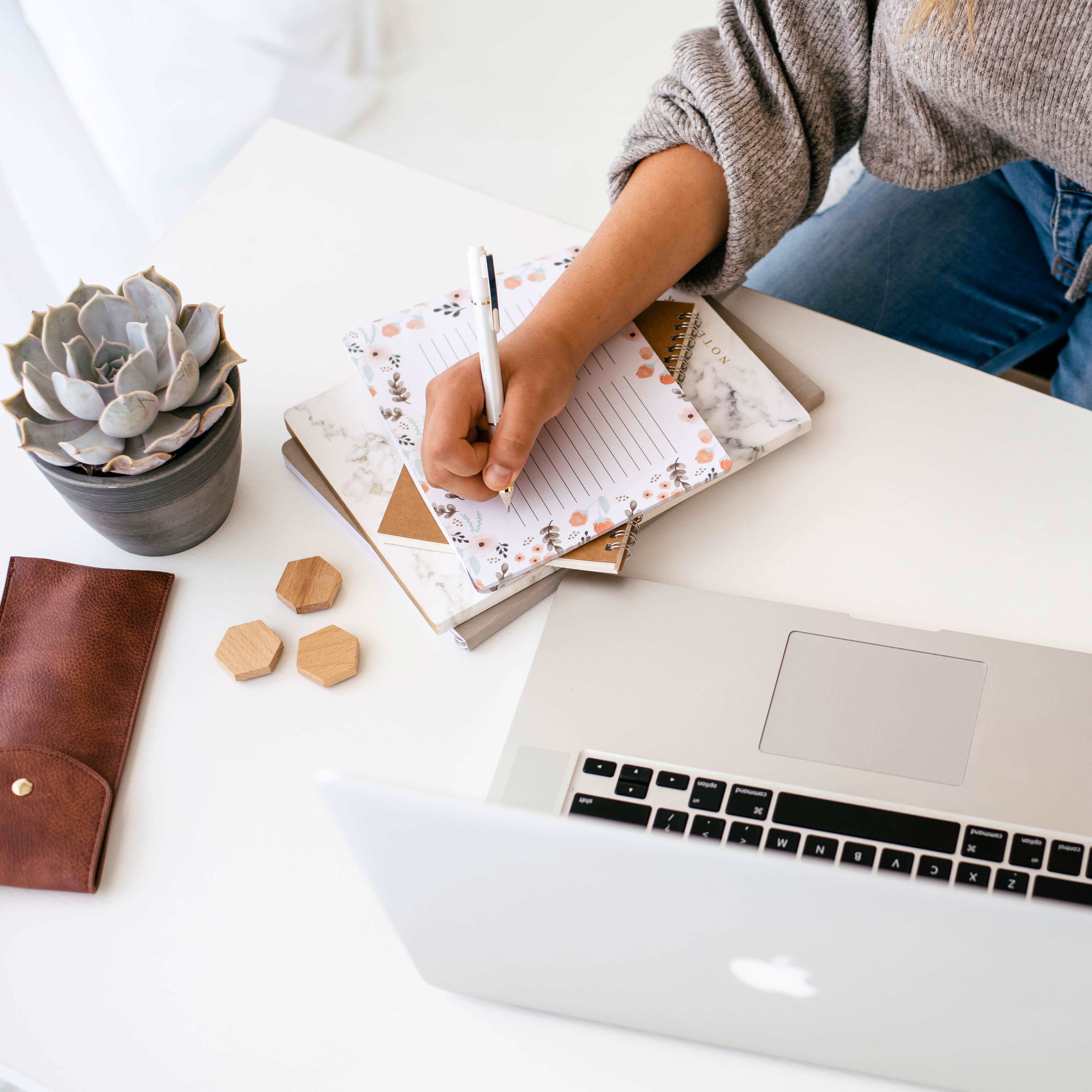 Woman writing in planner on how to track expenses