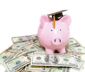 piggy bank with graduation cap, on cash