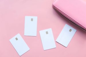 pink background with 4 white credit cards