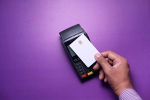 credit card and card reader with purple background